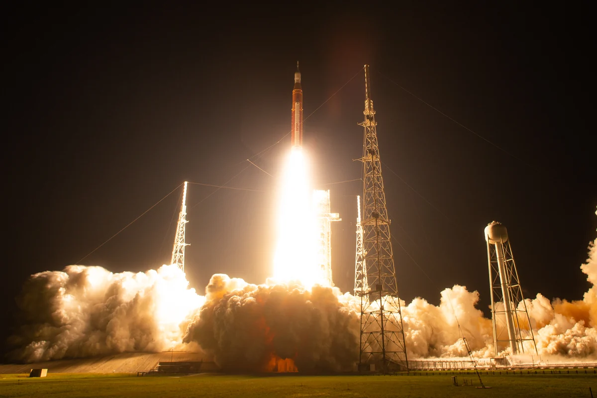 NASA Artemis I rocket lifting off at night, photographed by Joel Kowsky